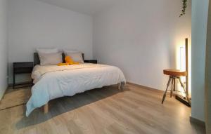 a bedroom with a bed with an orange stuffed animal on it at 2 Bedroom Nice Apartment In Oostende in Ostend +12 photos