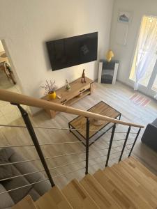 a living room with a flat screen tv on a wall at New Maison tout confort, bord de mer avec Parking Privé in Gruissan