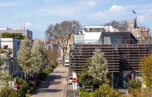 ein Gebäude in einer Stadtstraße mit Bäumen und Gebäuden in der Unterkunft 1 Bedroom Cozy Apartment In La Rochelle in La Rochelle