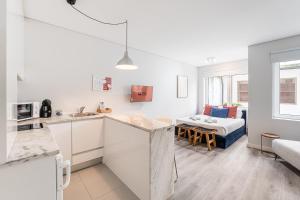a kitchen and a living room with a couch at GuestReady - Homely stay in Porto in Porto +34 photos
