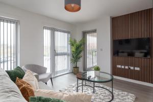 a living room with a couch and a glass table at Flat 6 Islay Court - Stylish 2 Bed Apartment Parking Great Location in Bletchley