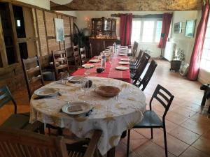 a large dining room with a long table with chairs at une fermette climatisée en pleine nature in Moirax