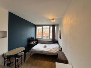 a small room with a bed and a table at Studio au coeur de Valence 22 in Valence