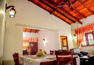 a living room with a table and a couch at Lucky Prince Villa & Ayurveda Wellness in Aluthgama