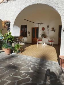 a large room with a table and chairs at Appartamento Belvedere in Azzone +5 photos