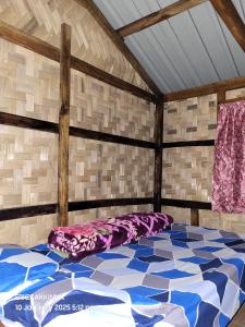 a bedroom with a large bed in a room at SafarnamaStays Homestay & Camping Warichora Meghalaya in Bāghamāra