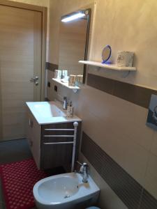 a bathroom with a sink and a toilet and a mirror at Il giardino della Contessa in Isernia