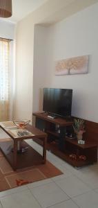 a living room with a television and a coffee table at Modern Apartment I & II by Irida Iris Group in Mytilene