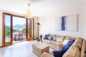 a living room with a couch and a table at Villa Sereni - 115 in Due Cossani