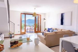 a living room with a couch and a table at Villa Sereni - 115 in Due Cossani
