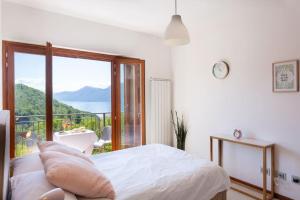 a bedroom with a bed and a large window at Villa Sereni - 115 in Due Cossani +16 photos