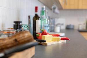 a block of cheese on a cutting board on a kitchen counter at No 2 Townhouse in Bishop Auckland