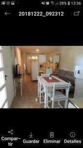 a kitchen and a living room with a white table at 5lunas reta pb in Balneario Océano +1 photo