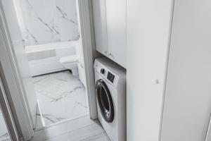 a washer and dryer in a bathroom at Lake View Apartment Iasi in Valea Lupului