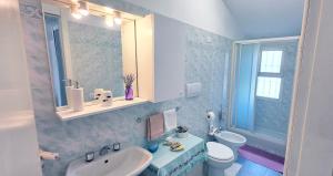 a bathroom with a sink and a toilet and a mirror at House of Millepini Relax Near Milan in Rodano