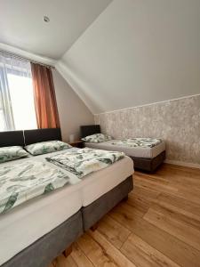Łóżko lub łóżka w pokoju w obiekcie Pensjonat Zatoka 17