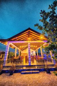 a large pavilion with lights on it at night at Beddegama Villa & Resort in Suriyawewa +1 photo