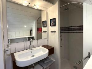 a bathroom with a sink and a shower and a mirror at Chambres d'Hôtes Couleurs du Temps in Périgueux +45 photos