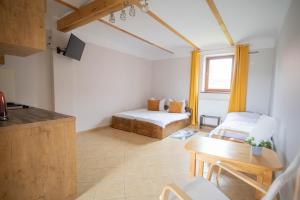 a living room with a bed and a table at Agroturystyka u Dorsza in Dąbrowa Człuchowska