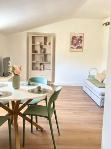 a living room with a table and chairs and a bed at Be Your Home - Olilà in Civitavecchia