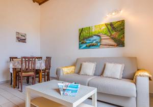 a living room with a couch and a table at Casa Mya-Relax al Porto, WiFi Veloce e Clima in Livorno