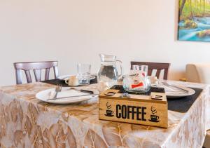a table with a box with a coffee sign on it at Casa Mya-Relax al Porto, WiFi Veloce e Clima in Livorno