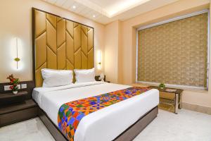 a bedroom with a large bed in a room at FabHotel Samotel - Nr Kolkata Airport in kolkata