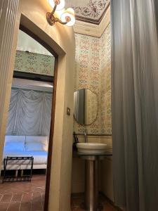 a bathroom with a sink and a bed at Le Suite Di Faenza in Faenza +26 photos