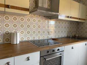 a kitchen with a sink and a stove at Casa Daniela in Fuentidueña