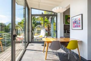 a dining room with a table and chairs at Luxury Lake Maggiore villa in Pallanza