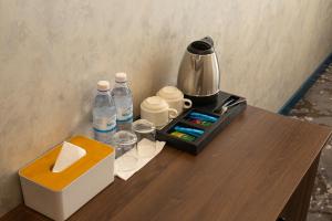a table with a coffee maker and water bottles on it at MILDOM Express in Almaty +22 photos