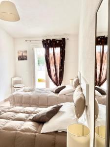 a bedroom with three beds and a window at Villa Etienne - Key to Villas in Valledoria
