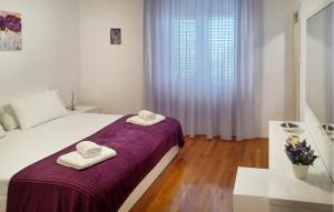 a white bedroom with two towels on a bed at Awesome Apartment In Otok Ist With Wifi in Ist