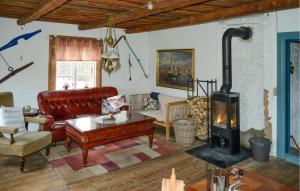 a living room with a wood stove in it at 3 Bedroom Lovely Home In Urshult in Urshult