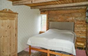 a bedroom with a bed and a window at 3 Bedroom Lovely Home In Urshult in Urshult +10 photos
