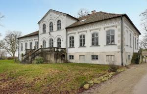 a large white house with a staircase in front of it at Nice Home In Ekeby With Wifi in Ekeby