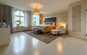 a bedroom with a bed and a couch and a chair at Nice Home In Ekeby With Wifi in Ekeby