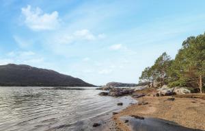a body of water with trees and a mountain at Gorgeous Home In Eivindvik With Wifi in Eivindvik +18 photos