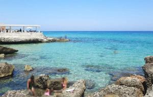 a view of the ocean from a rocky beach at Casal Del Borgo 3 in Ostuni
