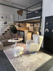 a living room with a couch and two chairs and a table at Apartment Zumbul in Zrenjanin