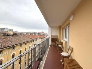 a balcony with chairs and a view of a city at Trieste Mia Rooms in Trieste +32 photos