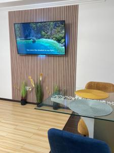 a living room with a tv on a wall at MilitariResidence Luxury 54 in Roşu +30 photos