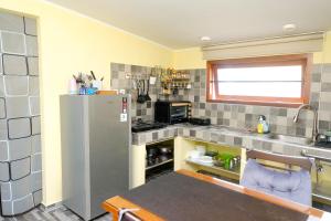 a kitchen with a stainless steel refrigerator and a sink at Amaro Homestay in Nuhu Tawun +71 photos