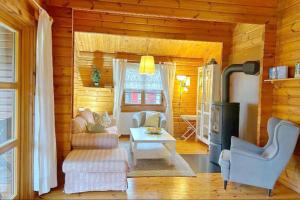 a living room of a log cabin with a fireplace at Ferienhaus Neckar 58 in Hayingen