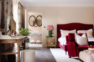 a bedroom with a red bed and a red chair at Saltmoore in Whitby +59 photos