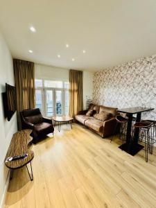 a living room with a couch and a table at Apartamentos Apolo in Madrid