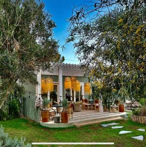 a house with a deck with chairs and trees at Villa Nour in Essaouira