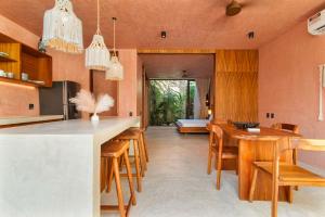 an open kitchen and dining room with a table and chairs at Private & Modern 2-BR Villa of La Veleta in Tulum
