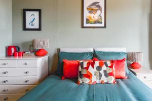 a bedroom with a blue bed and a white dresser at Smarties Guest House in Newquay