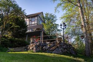a house on a hill with a pile of rocks at Jachthuus mit Anbau in Brilon